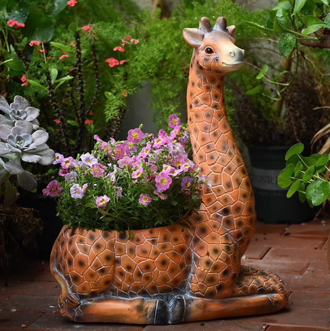 sitting giraffe with plants and flowers